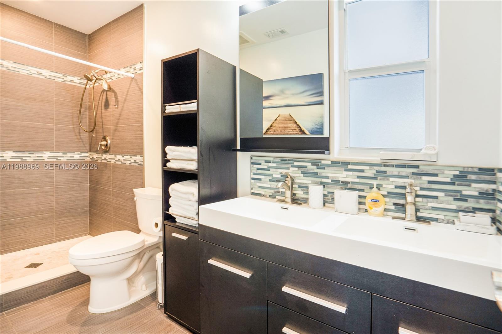 113 Southwest 2nd Street Hallandale Beach, FL 33009 - Photo 20 of 50 a bathroom with a sink a toilet and shower