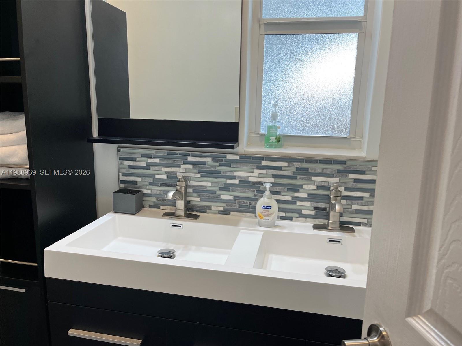 113 Southwest 2nd Street Hallandale Beach, FL 33009 - Photo 21 of 50 a bathroom with a sink and a mirror