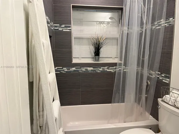 a bedroom with a bed and a mirror