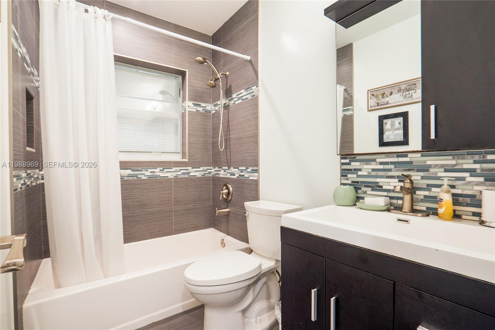 113 Southwest 2nd Street Hallandale Beach, FL 33009 - Photo 26 of 50 a bathroom with a sink toilet tub and shower