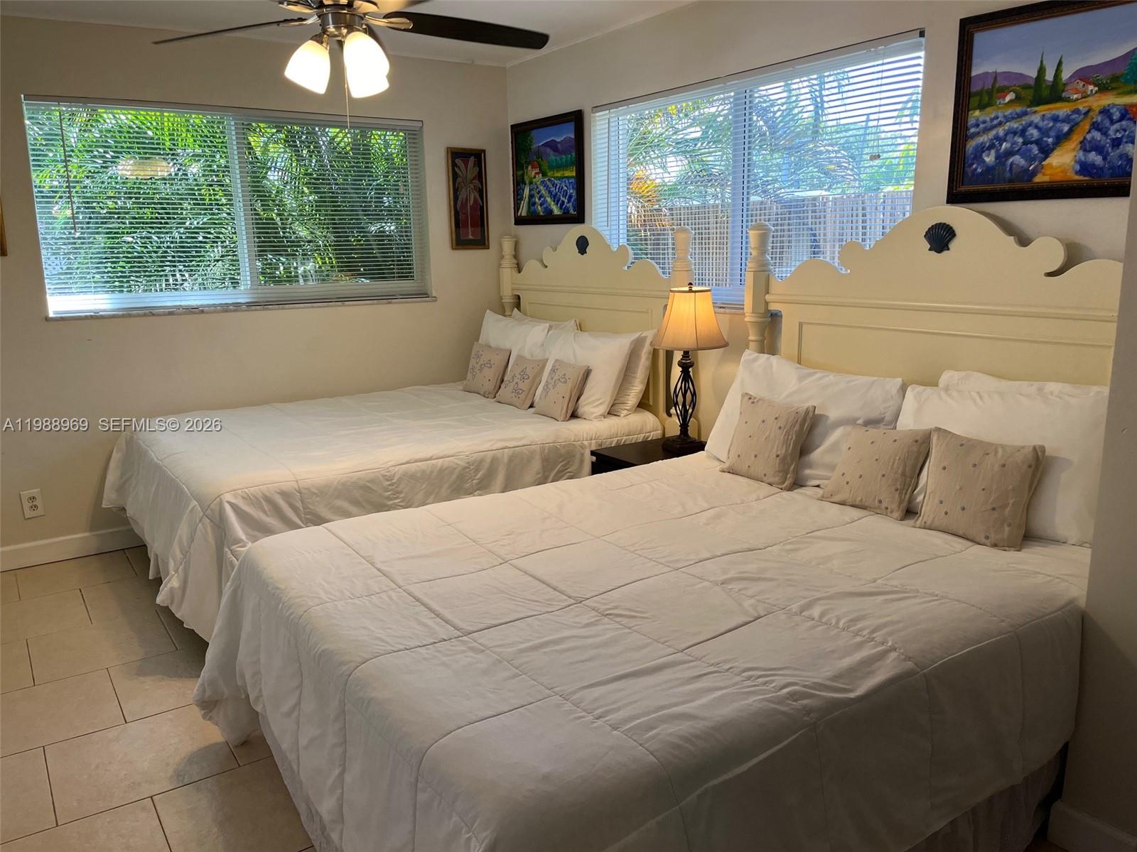 113 Southwest 2nd Street Hallandale Beach, FL 33009 - Photo 30 of 50 a bedroom with a large bed and a large window