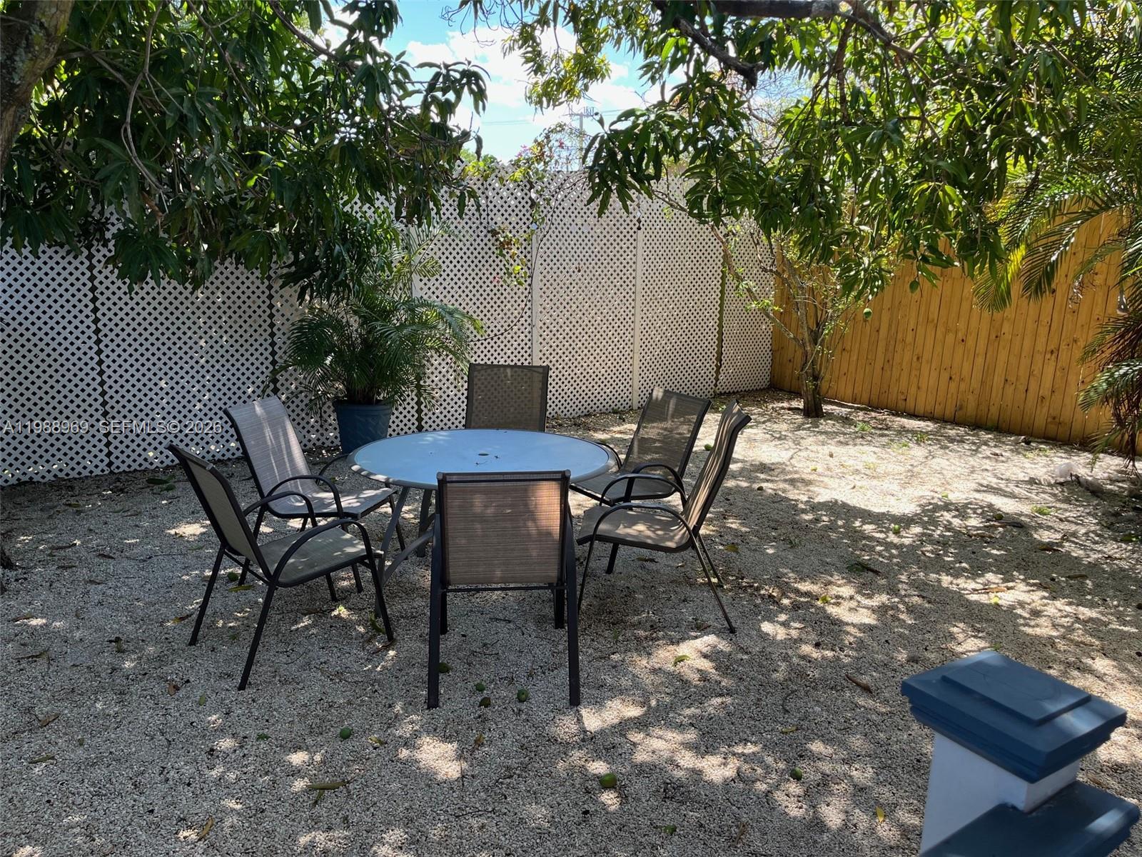 113 Southwest 2nd Street Hallandale Beach, FL 33009 - Photo 40 of 50 a view of a backyard with a table and chairs