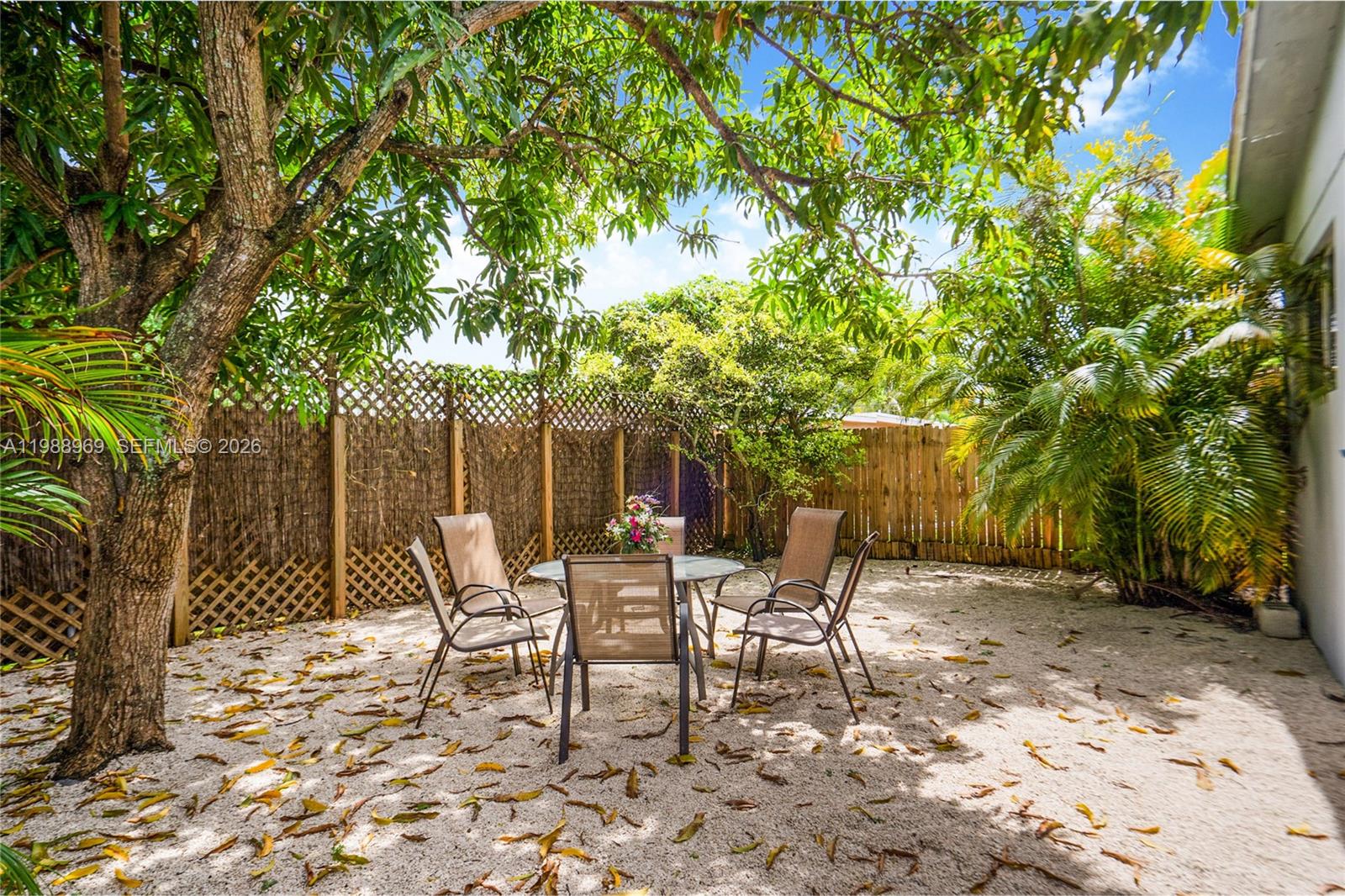 113 Southwest 2nd Street Hallandale Beach, FL 33009 - Photo 4 of 50 a view of a chairs and table in backyard