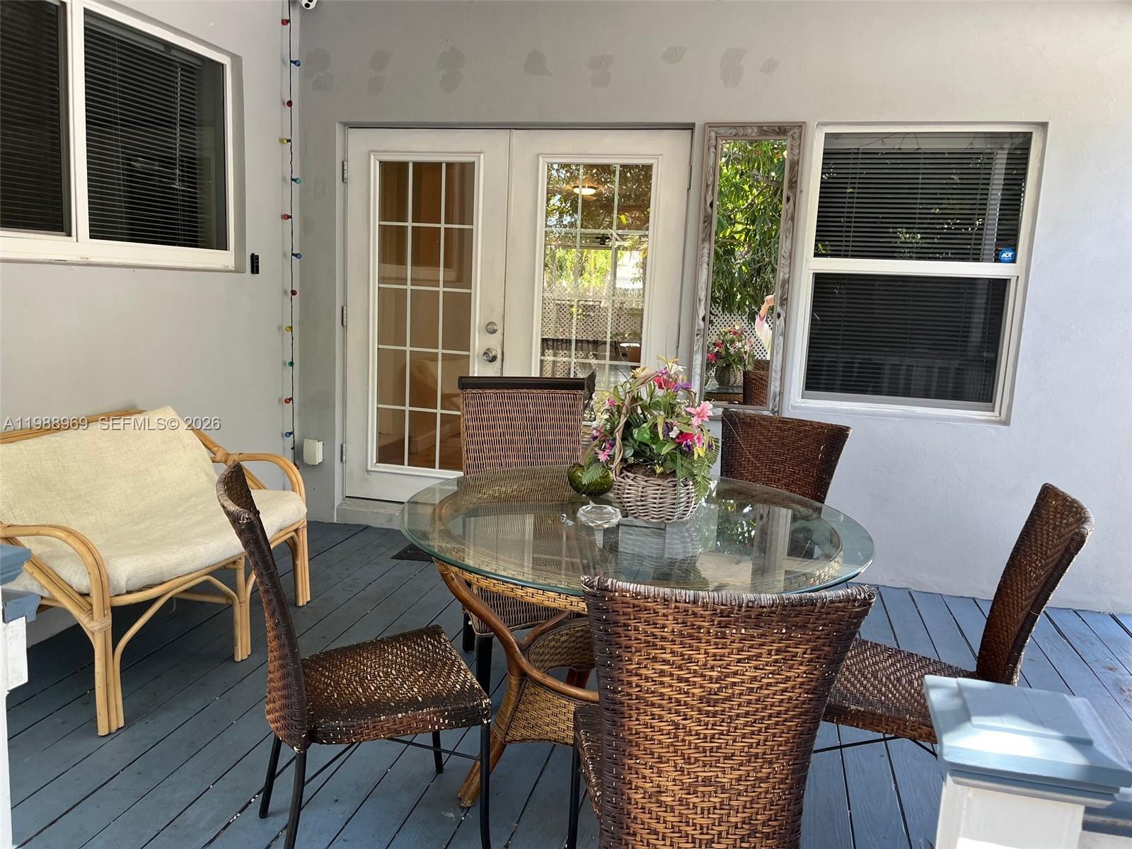 113 Southwest 2nd Street Hallandale Beach, FL 33009 - Photo 41 of 50 a dining room with furniture window and wooden floor