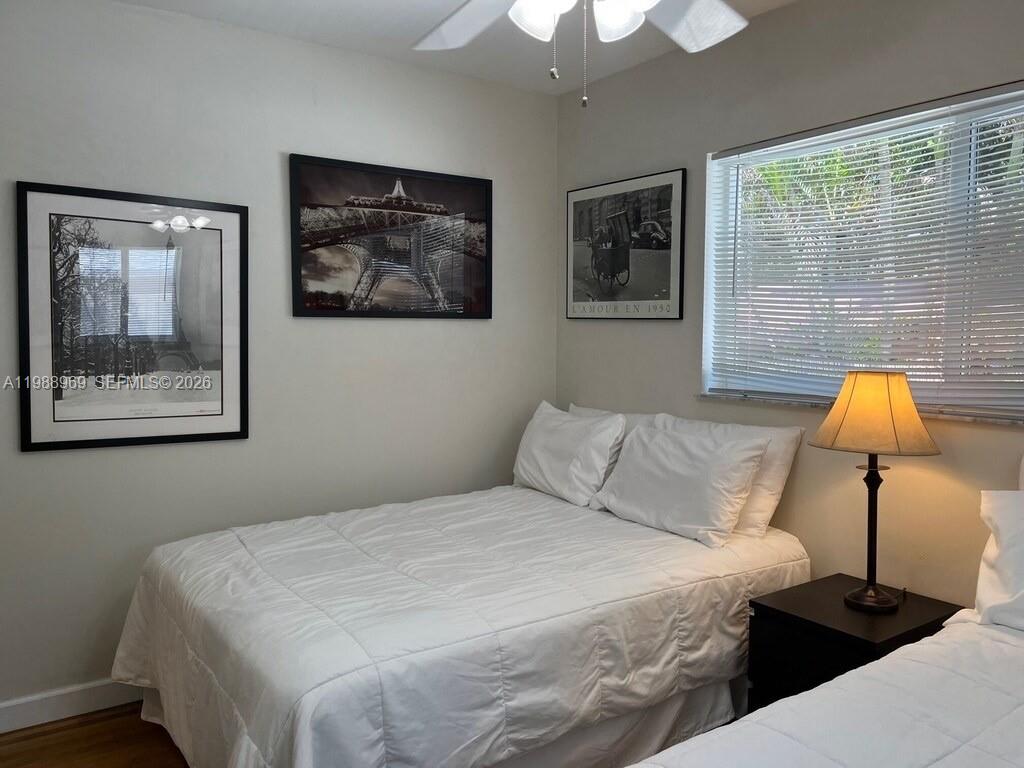 113 Southwest 2nd Street Hallandale Beach, FL 33009 - Photo 44 of 50 a bedroom with a bed and a painting on the wall