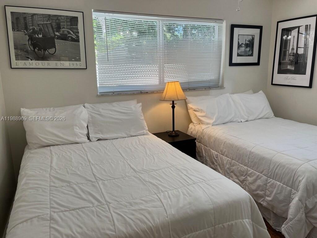 113 Southwest 2nd Street Hallandale Beach, FL 33009 - Photo 46 of 50 a bedroom with two beds and painting on the wall