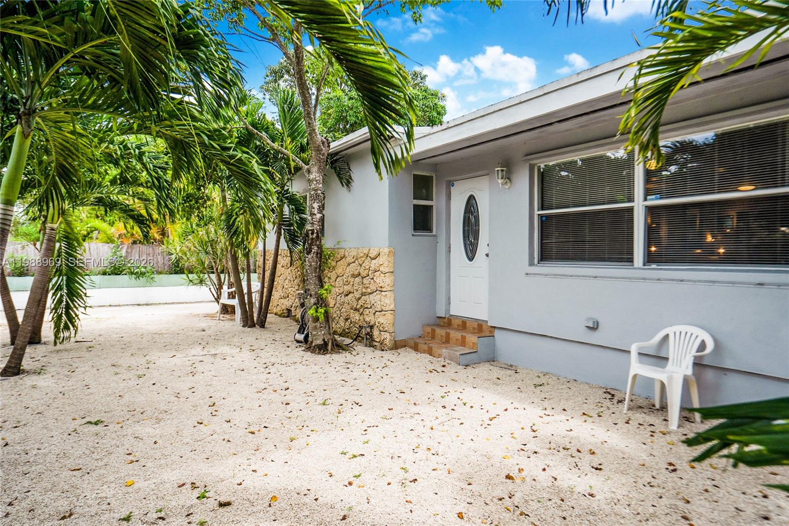 113 Southwest 2nd Street Hallandale Beach, FL 33009 - Photo 48 of 50 a front view of a house with a yard