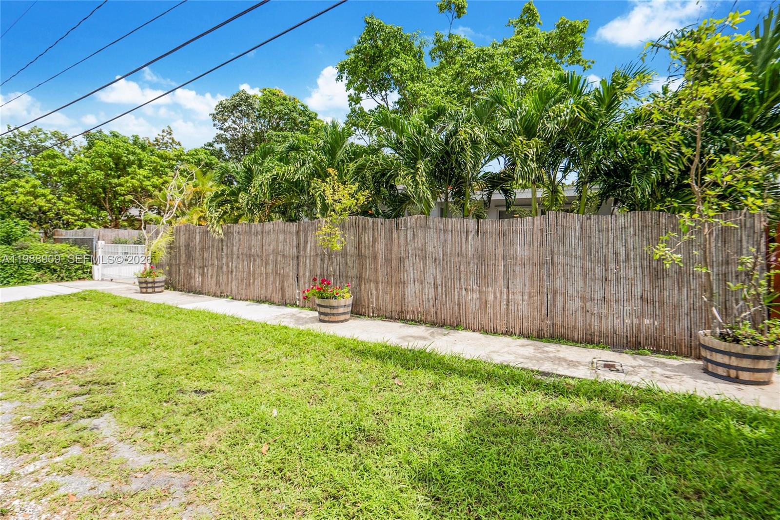 113 Southwest 2nd Street Hallandale Beach, FL 33009 - Photo 50 of 50 a view of outdoor space with a wooden fence