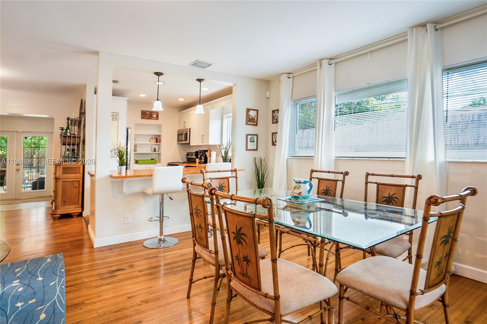113 Southwest 2nd Street Hallandale Beach, FL 33009 - Photo 7 of 50 a view of a dining room with furniture and wooden floor