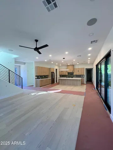 a view of a hall with kitchen and windows