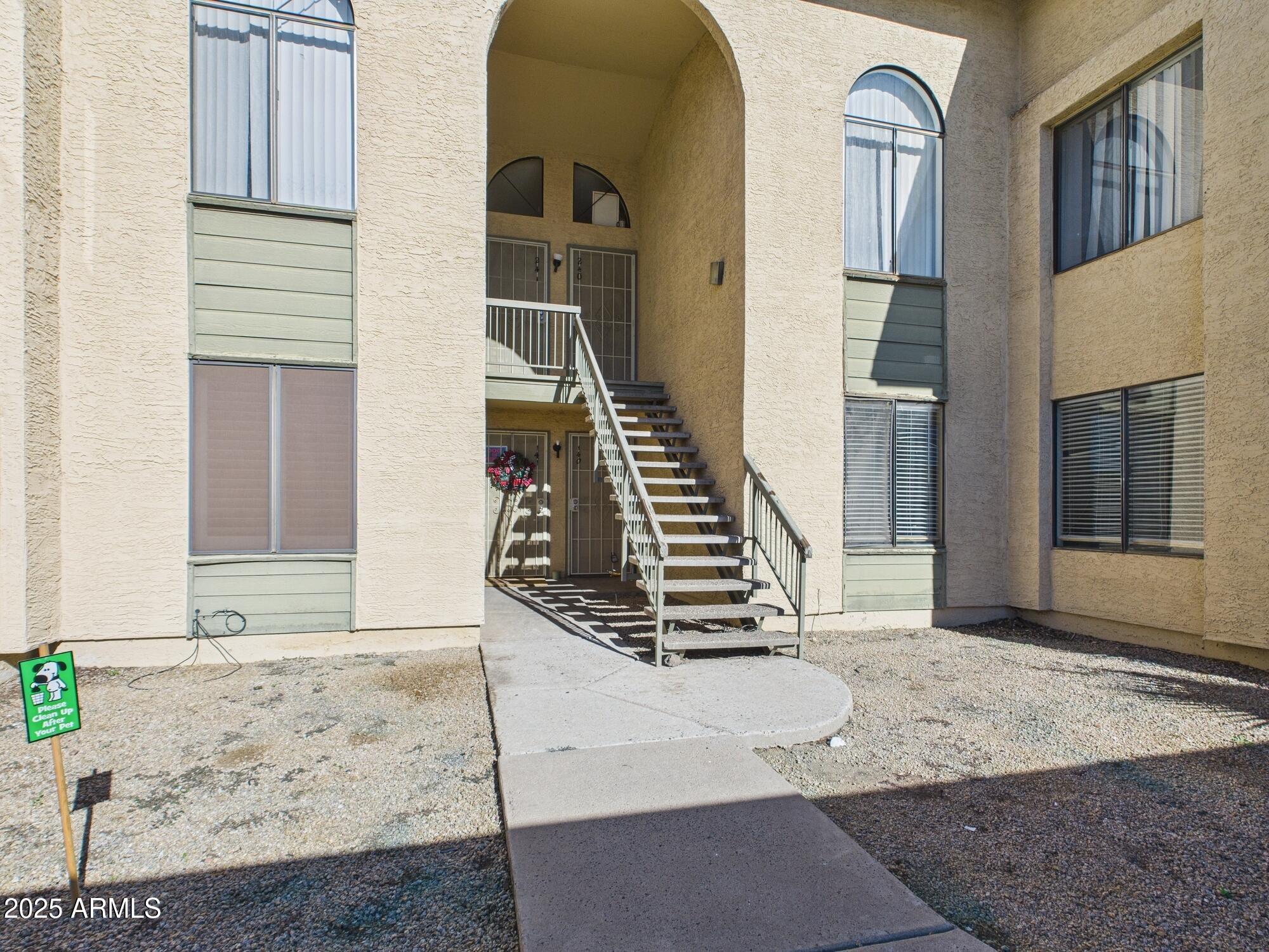 a view of an entryway with wooden floor and stairs