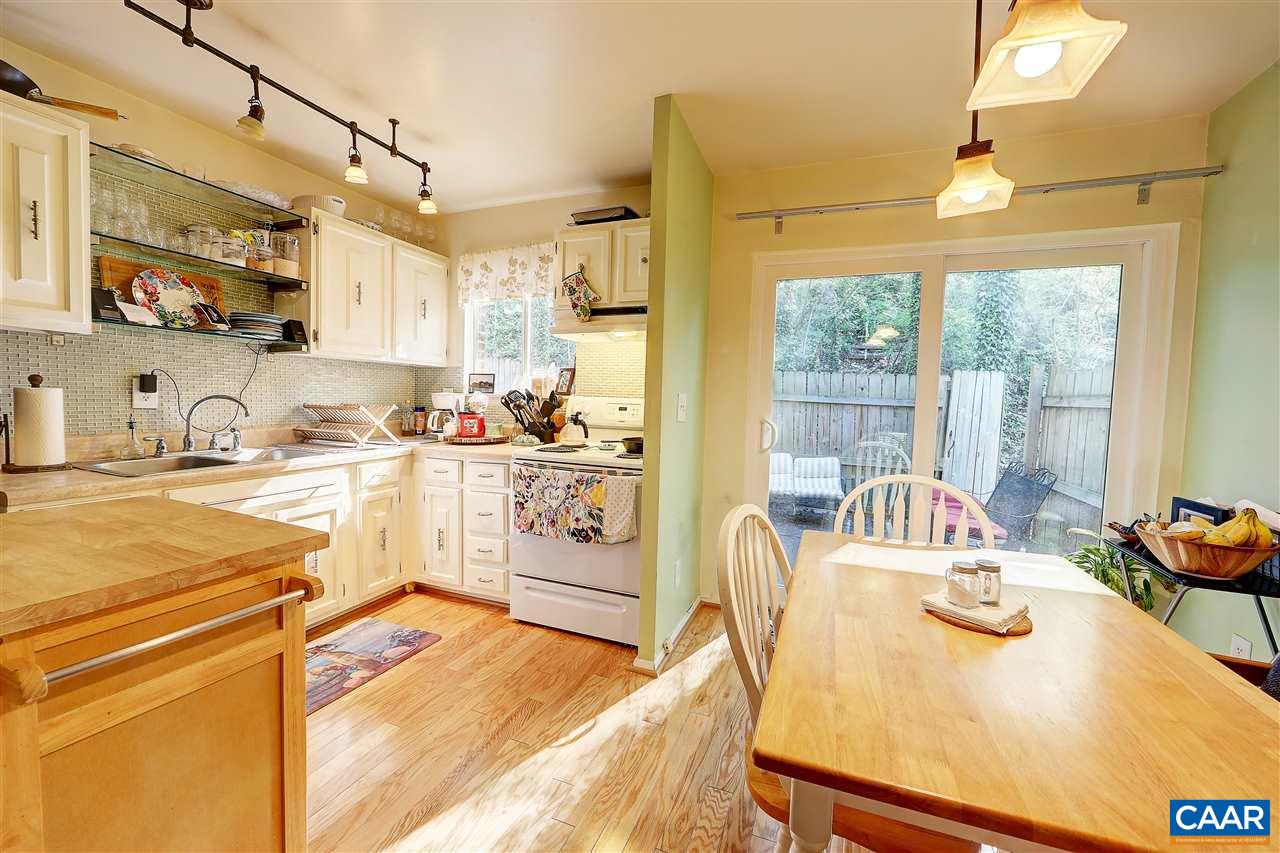 405 Valley Rd Extension, Unit B Charlottesville, VA 22903 - Photo 7 of 11 a kitchen with a refrigerator a stove and a sink with wooden floor