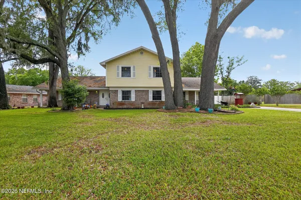 a front view of house with yard and green space