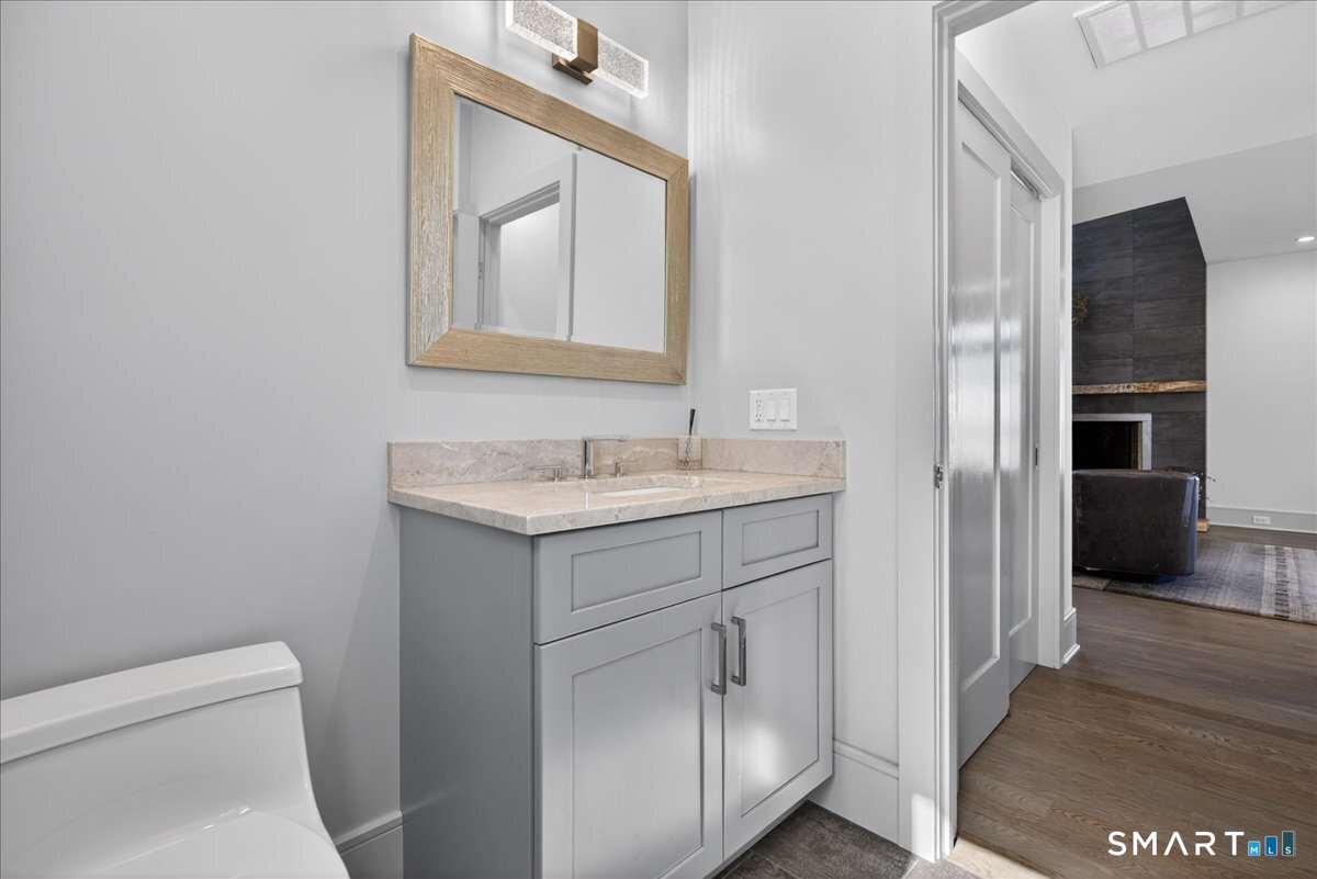 33 Pearl Street Milford, CT 06460 - Photo 15 of 38 a bathroom with a toilet sink and mirror