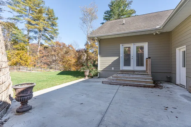 wooden floor fireplace and windows in an empty room
