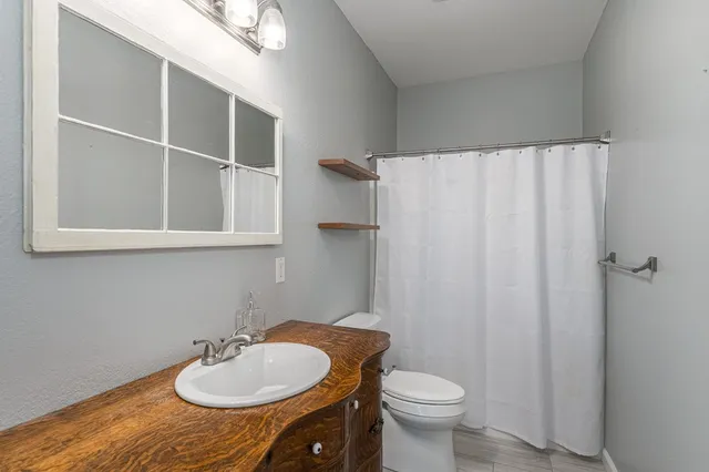 a kitchen with stainless steel appliances granite countertop a sink a stove and cabinets