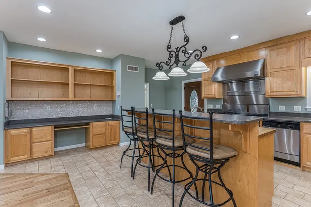a view of a kitchen with a dining table chairs and wooden floor