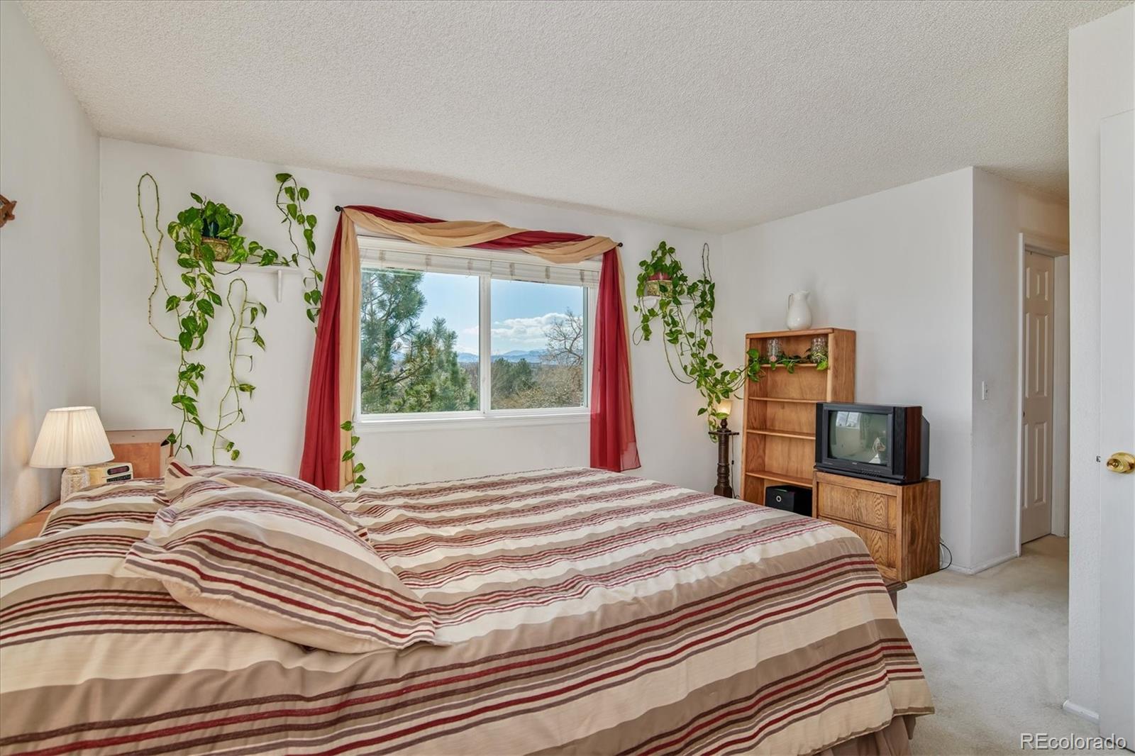 462 Northridge Road Highlands Ranch, CO 80126 - Photo 17 of 36 a bedroom with a bed and a large window