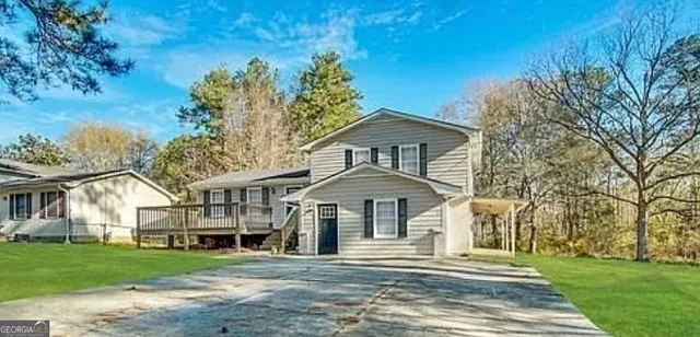 a front view of a house with a garden