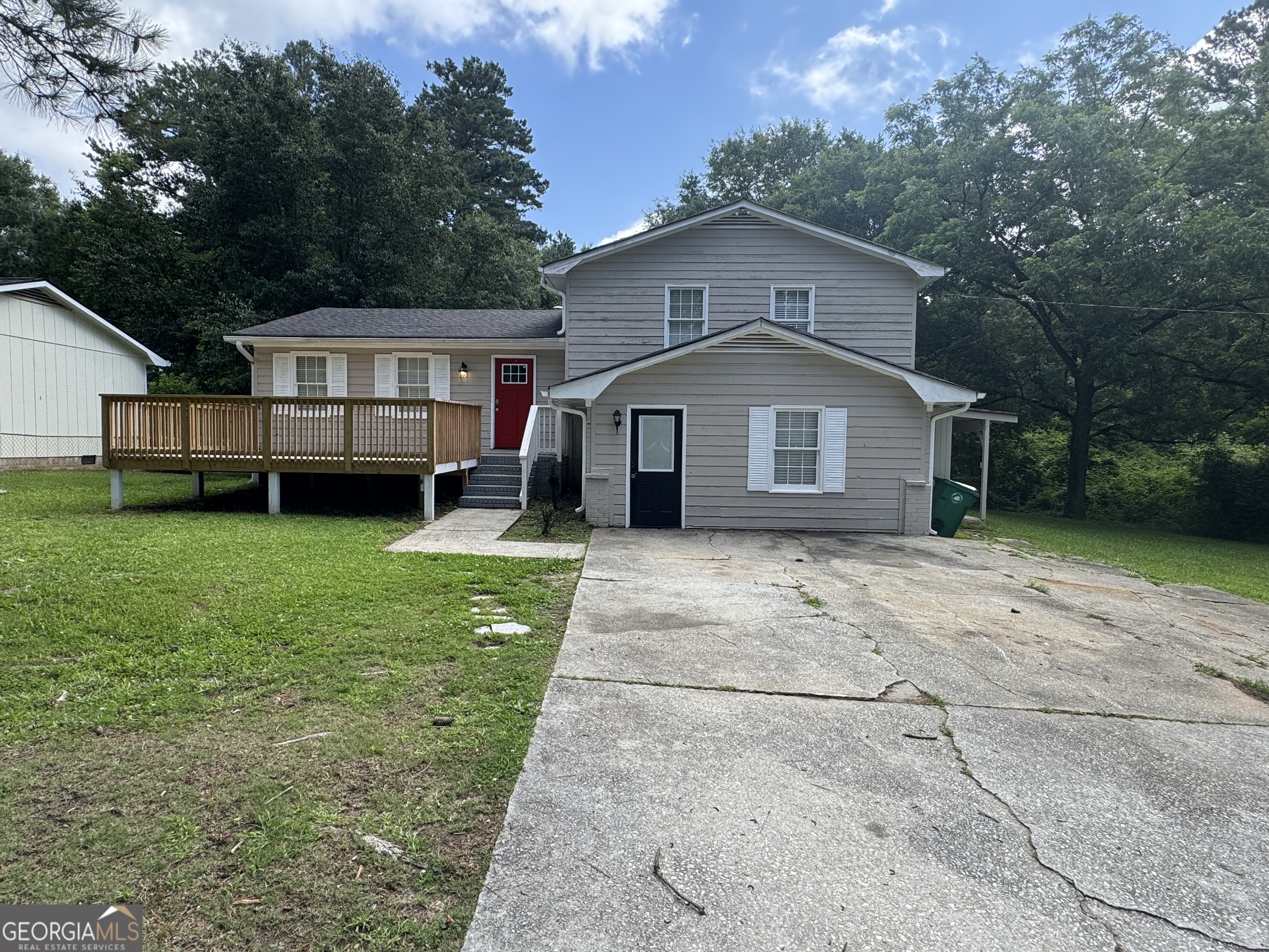 8347 Union Grove Road Lithonia, GA 30058 - Photo 2 of 9 a front of a house with a garden and trees