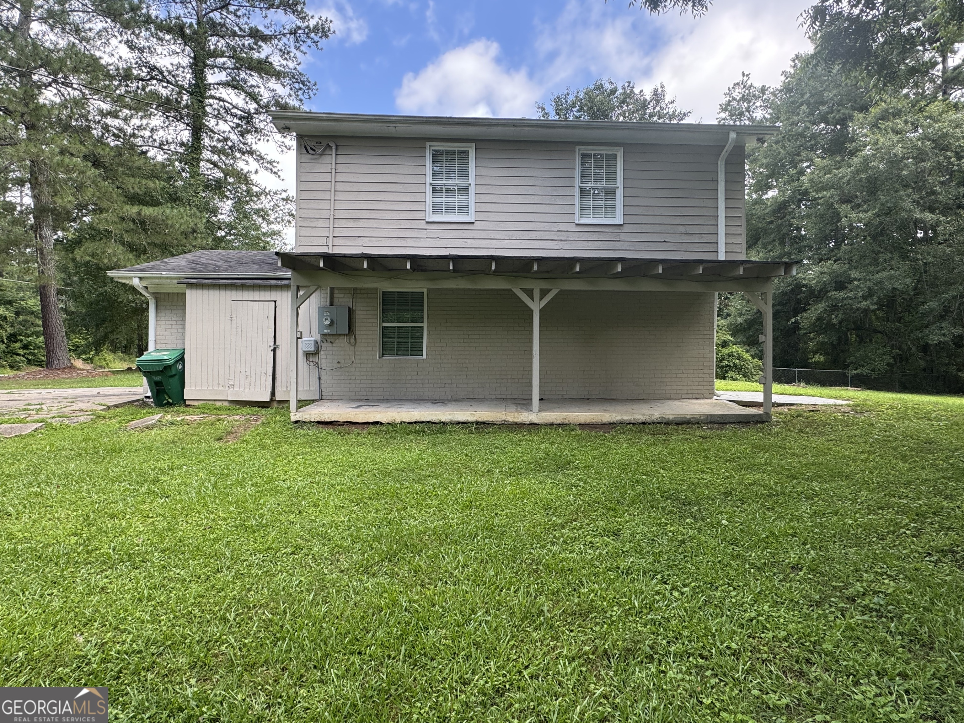 8347 Union Grove Road Lithonia, GA 30058 - Photo 3 of 9 a view of a house with backyard