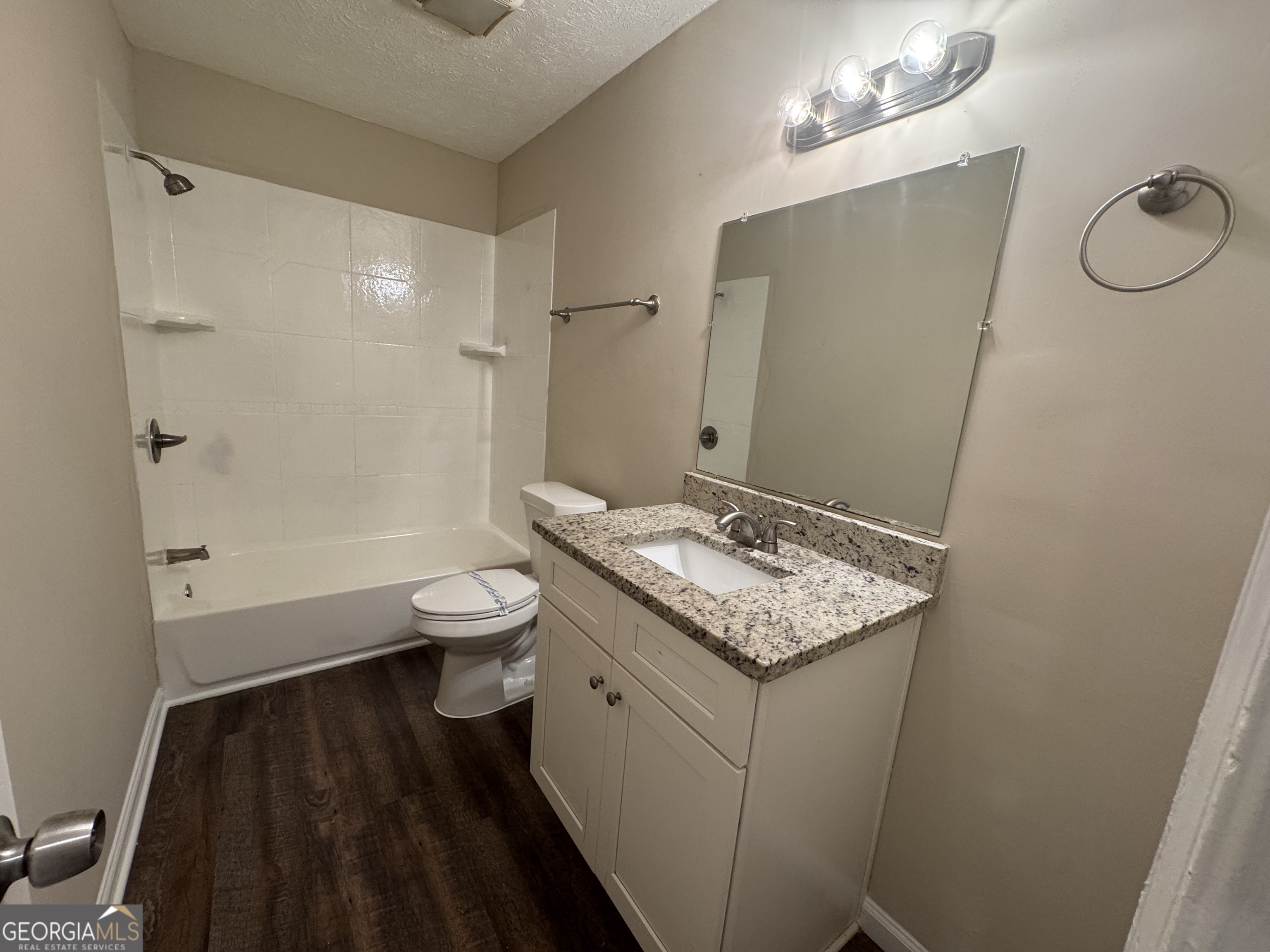 8347 Union Grove Road Lithonia, GA 30058 - Photo 7 of 9 a bathroom with a granite countertop sink a toilet and shower