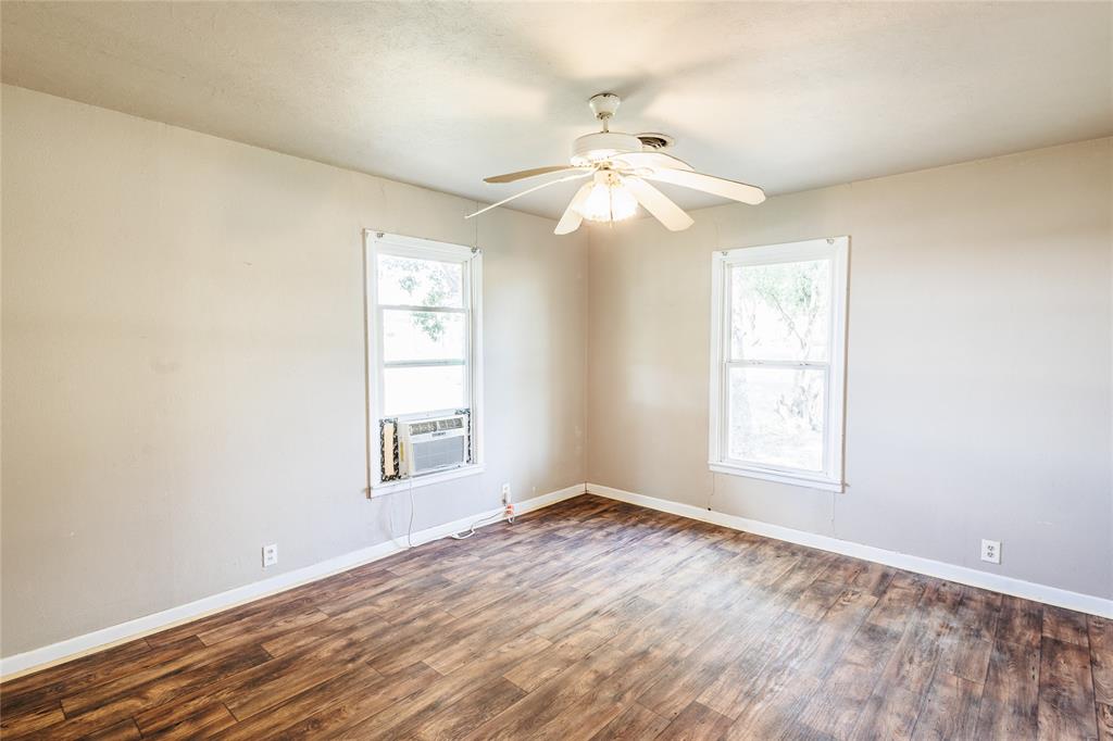 202 North Sycamore Malone, TX 76660 - Photo 18 of 22 an empty room with windows and fan