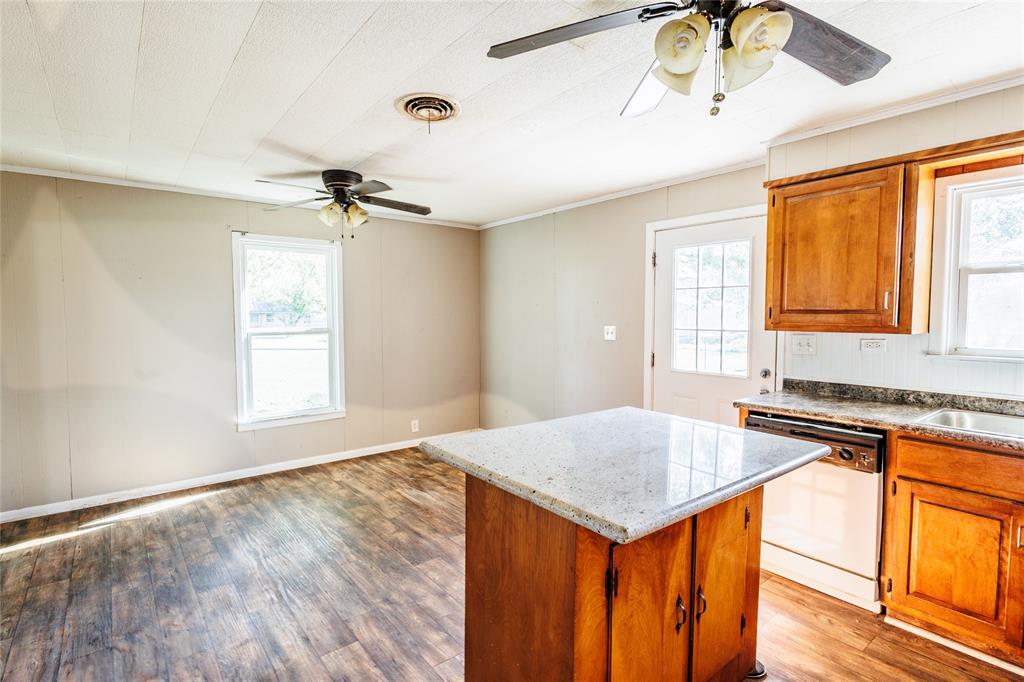 202 North Sycamore Malone, TX 76660 - Photo 7 of 22 a kitchen with a stove a sink and a refrigerator