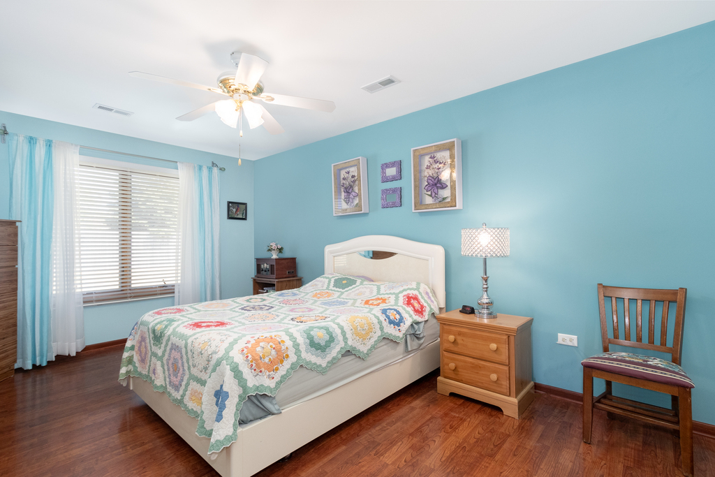 2425 Par 4 Court Joliet, IL 60436 - Photo 8 of 16 a bedroom with a bed and wooden floor
