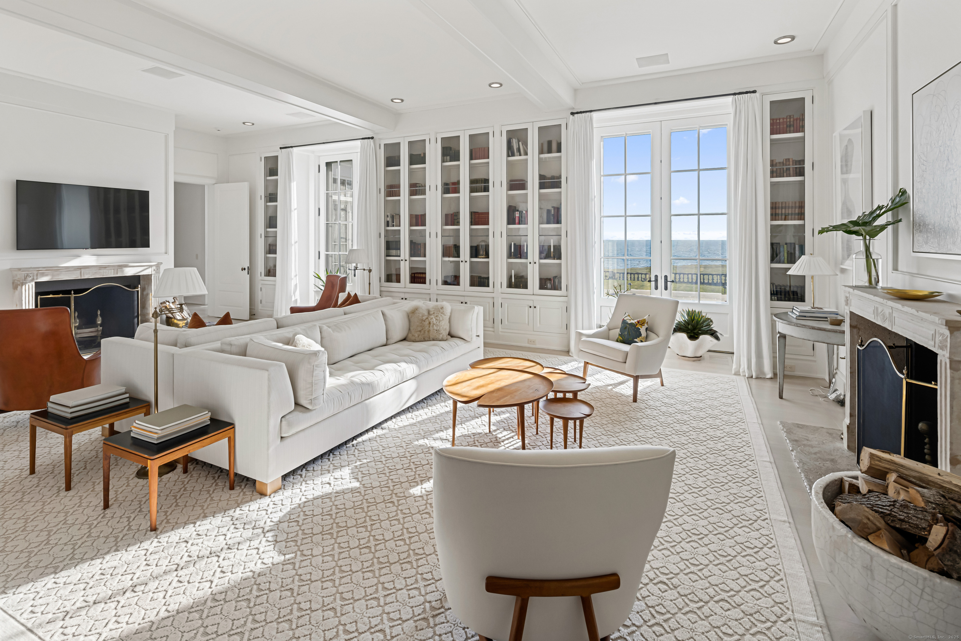 1131 Sasco Hill Road Fairfield, CT 06824 - Photo 11 of 40 a living room with furniture a flat screen tv and a fireplace