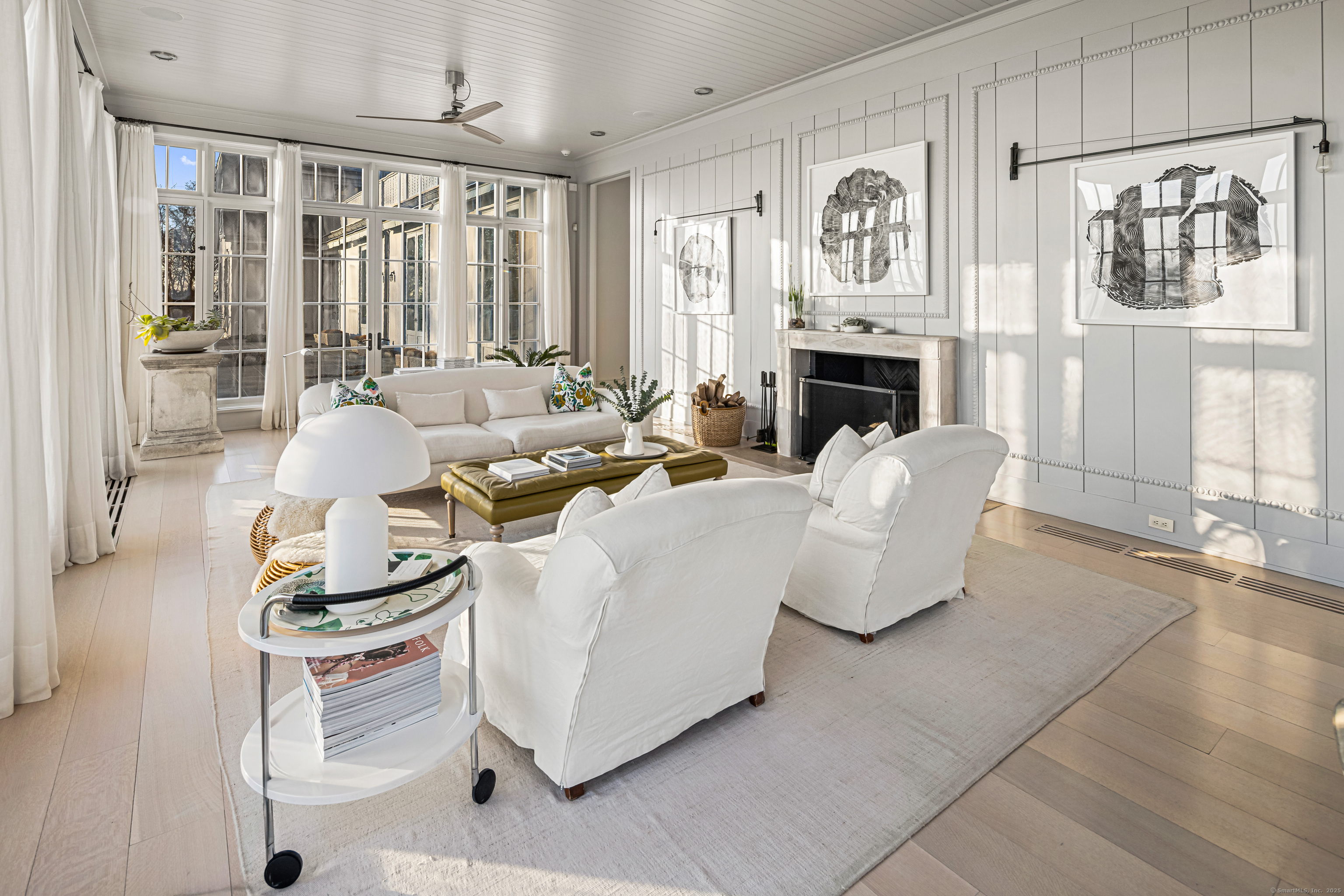 1131 Sasco Hill Road Fairfield, CT 06824 - Photo 14 of 40 a living room with furniture a fireplace and a large window