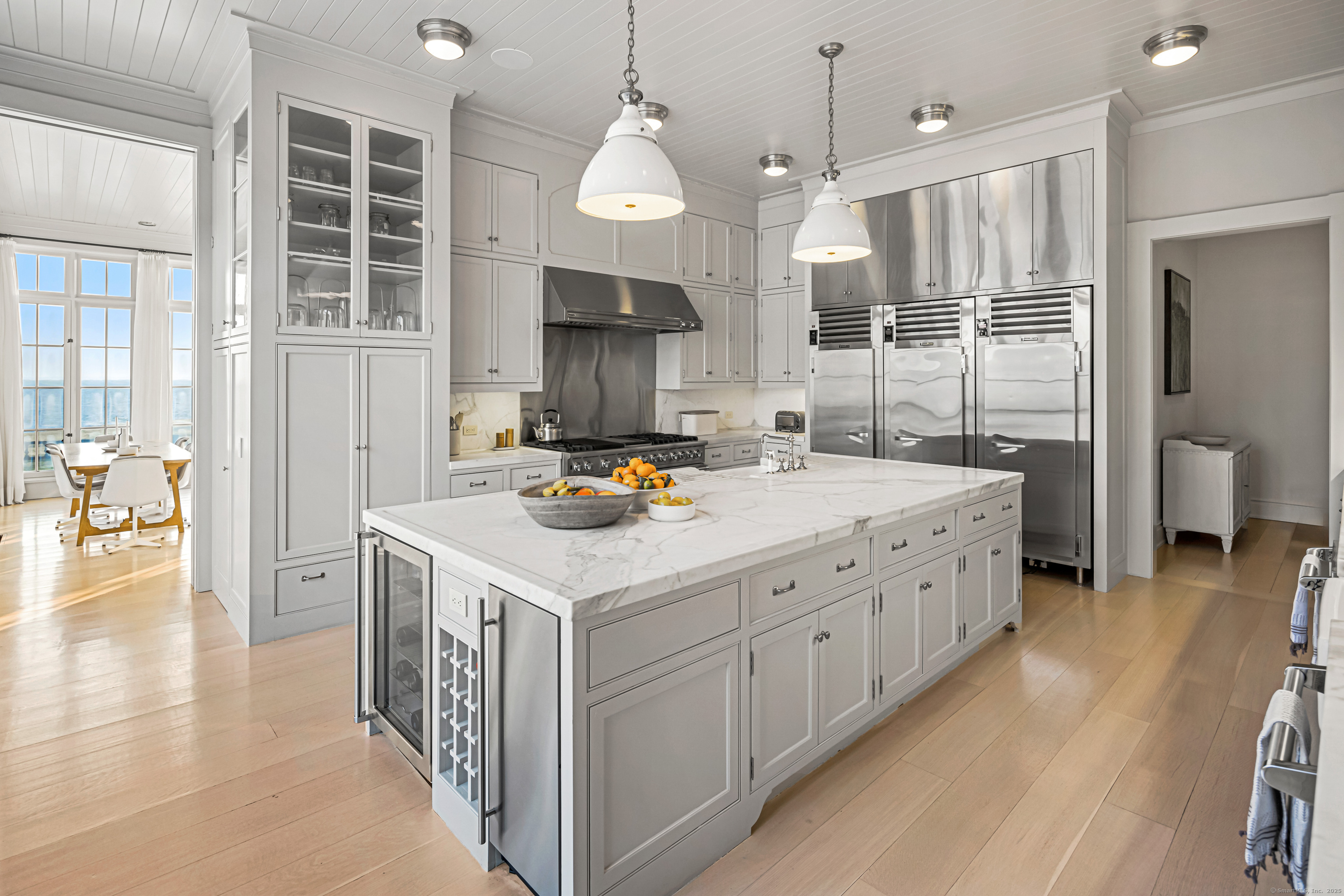 1131 Sasco Hill Road Fairfield, CT 06824 - Photo 16 of 40 a kitchen with sink cabinets and wooden floor