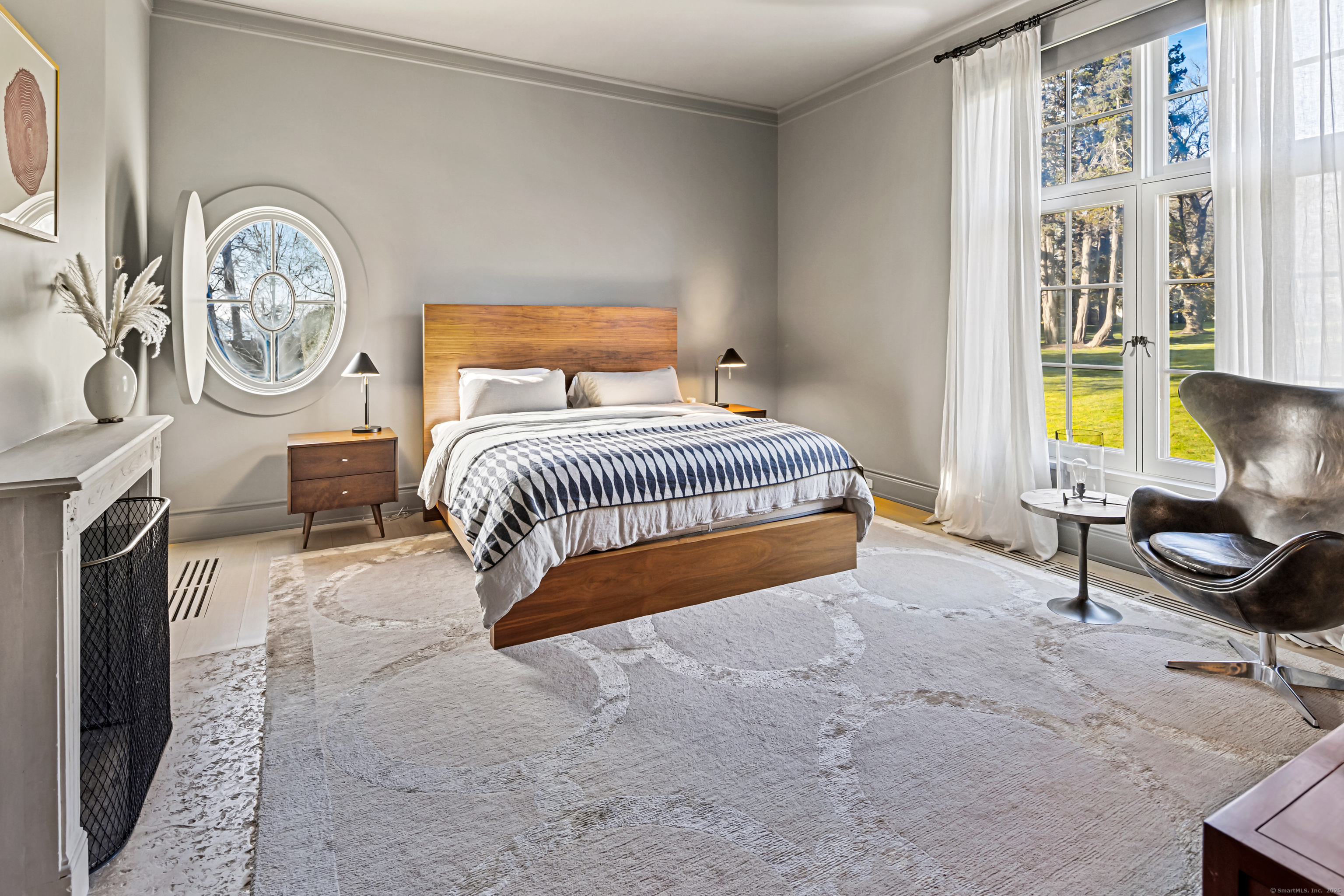 1131 Sasco Hill Road Fairfield, CT 06824 - Photo 20 of 40 a spacious bedroom with a bed a painting on the wall and a window