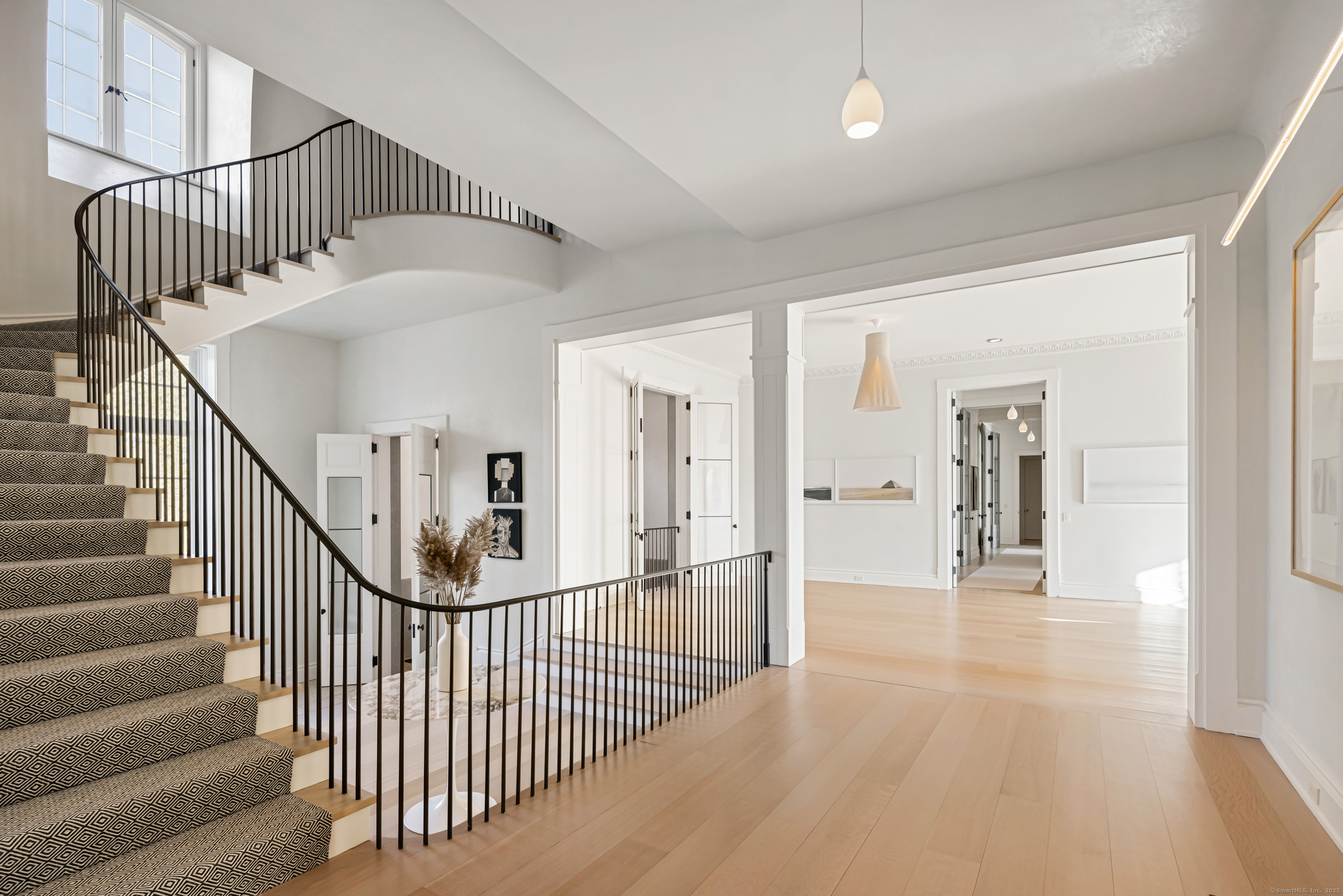 1131 Sasco Hill Road Fairfield, CT 06824 - Photo 21 of 40 a view of staircase with white walls and white floor