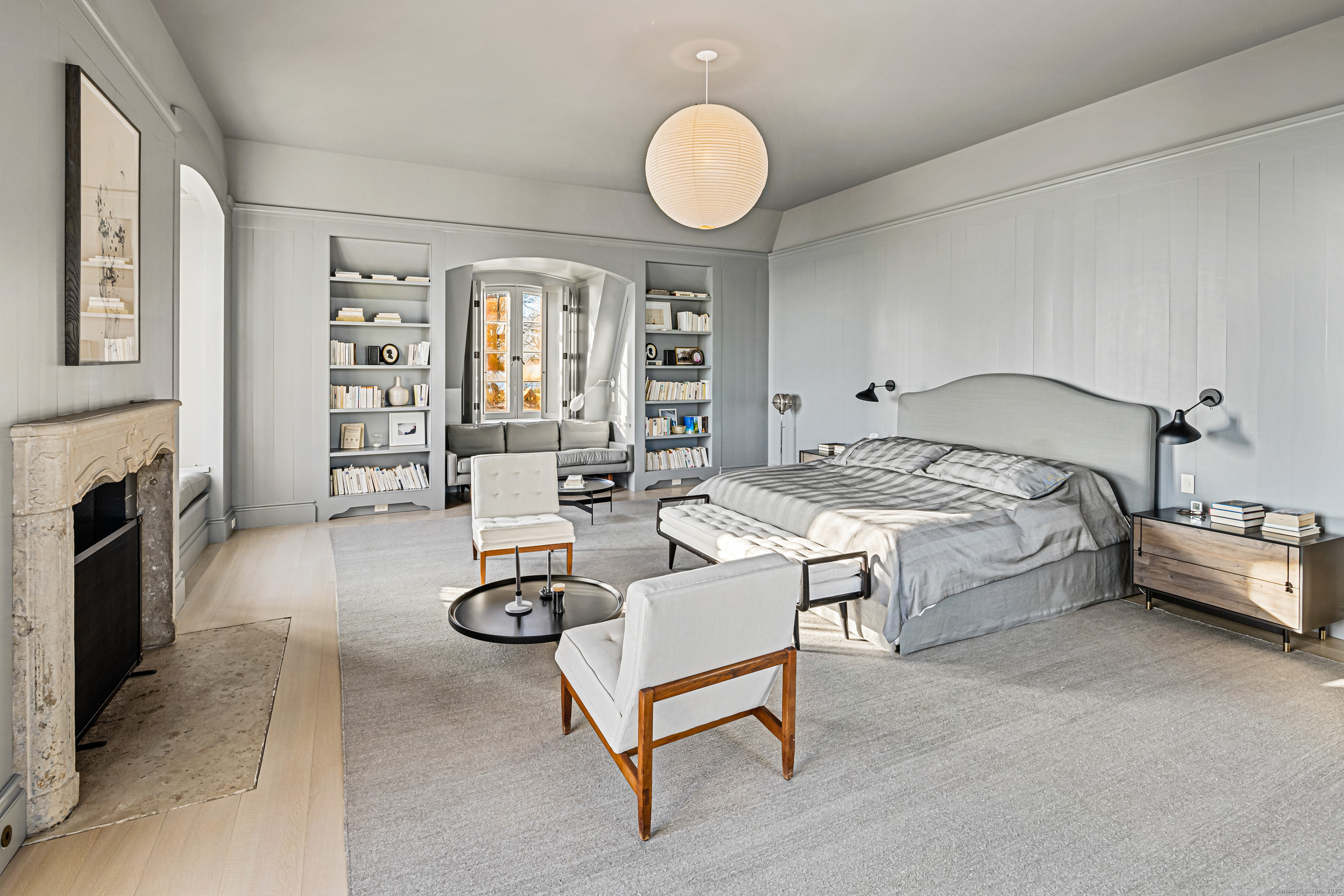 1131 Sasco Hill Road Fairfield, CT 06824 - Photo 23 of 40 a spacious bedroom with a bed and a chandelier