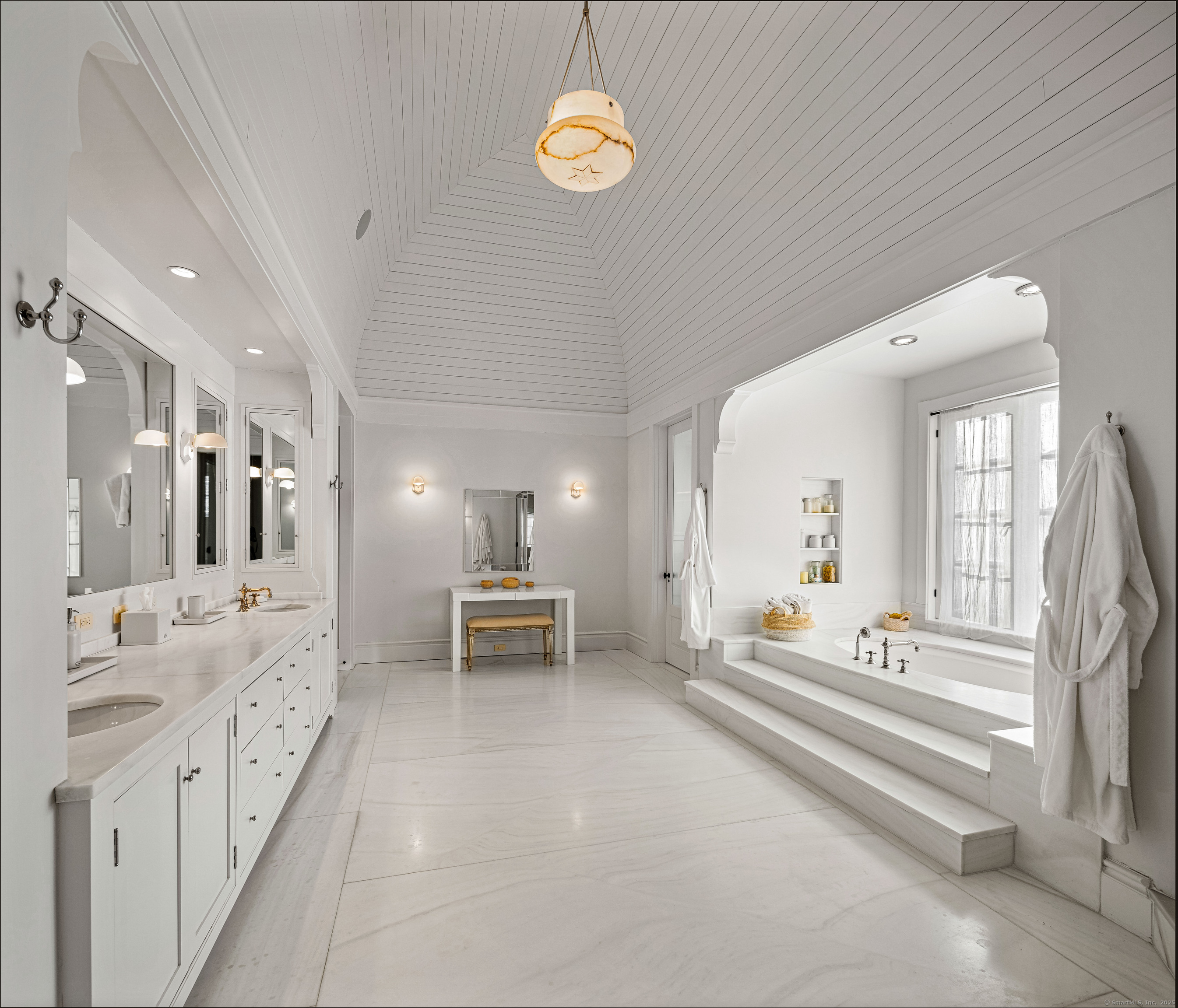 1131 Sasco Hill Road Fairfield, CT 06824 - Photo 24 of 40 a spacious bathroom with a double vanity sink a chandelier and a bathtub