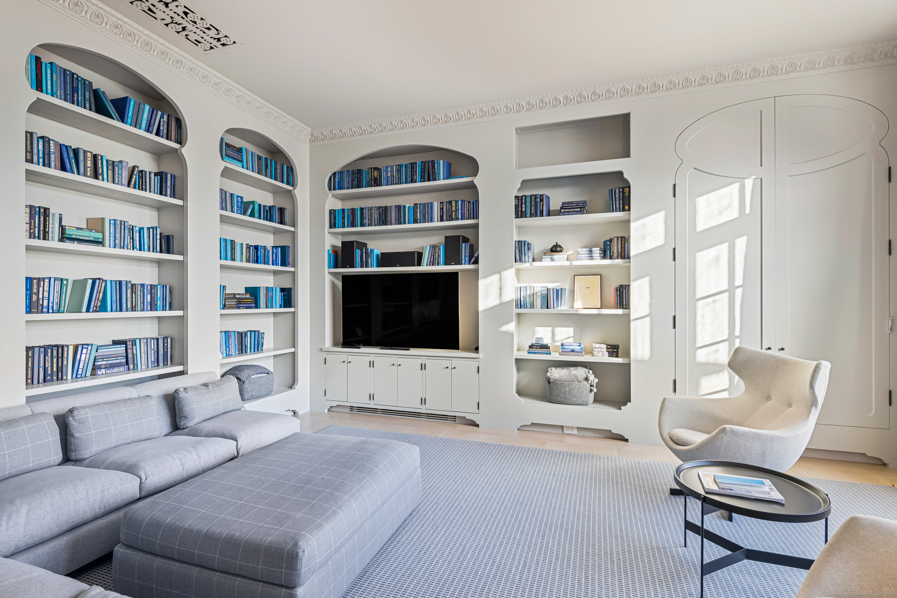 1131 Sasco Hill Road Fairfield, CT 06824 - Photo 25 of 40 a living room with furniture workspace and a bookshelf