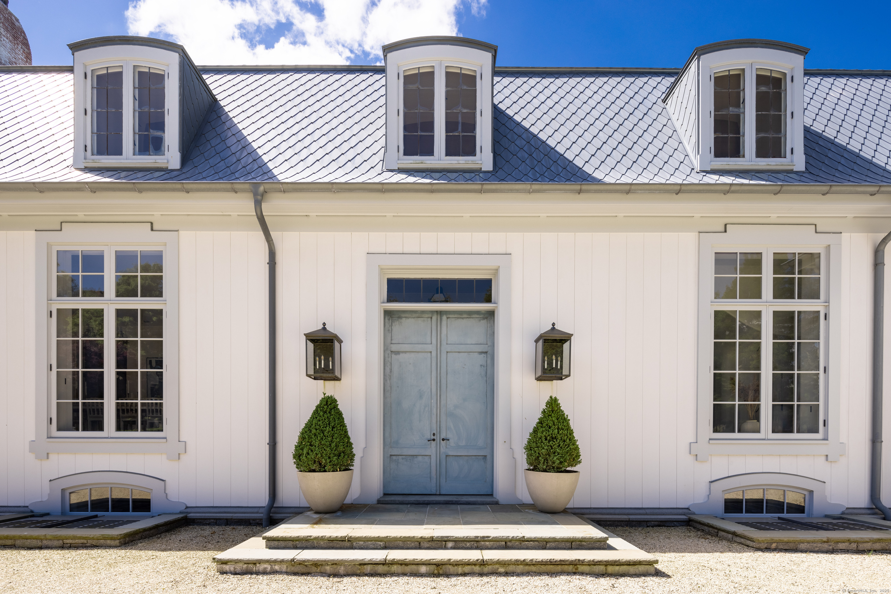1131 Sasco Hill Road Fairfield, CT 06824 - Photo 5 of 40 a front view of a house with large windows