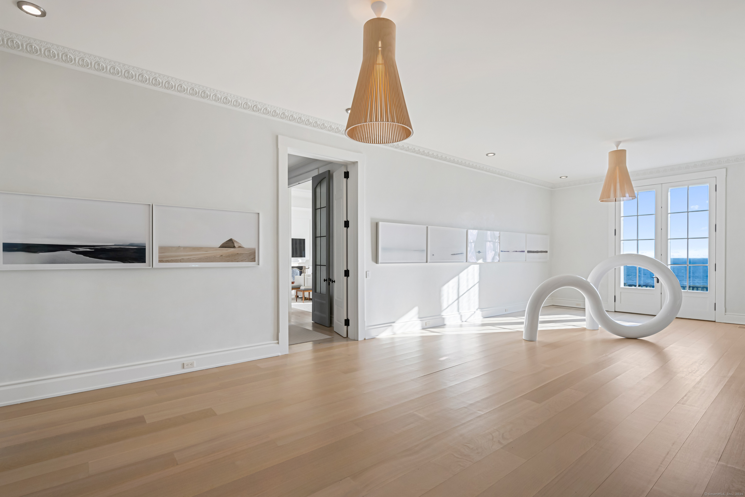 1131 Sasco Hill Road Fairfield, CT 06824 - Photo 7 of 40 a room with lots of white furniture and wooden floor