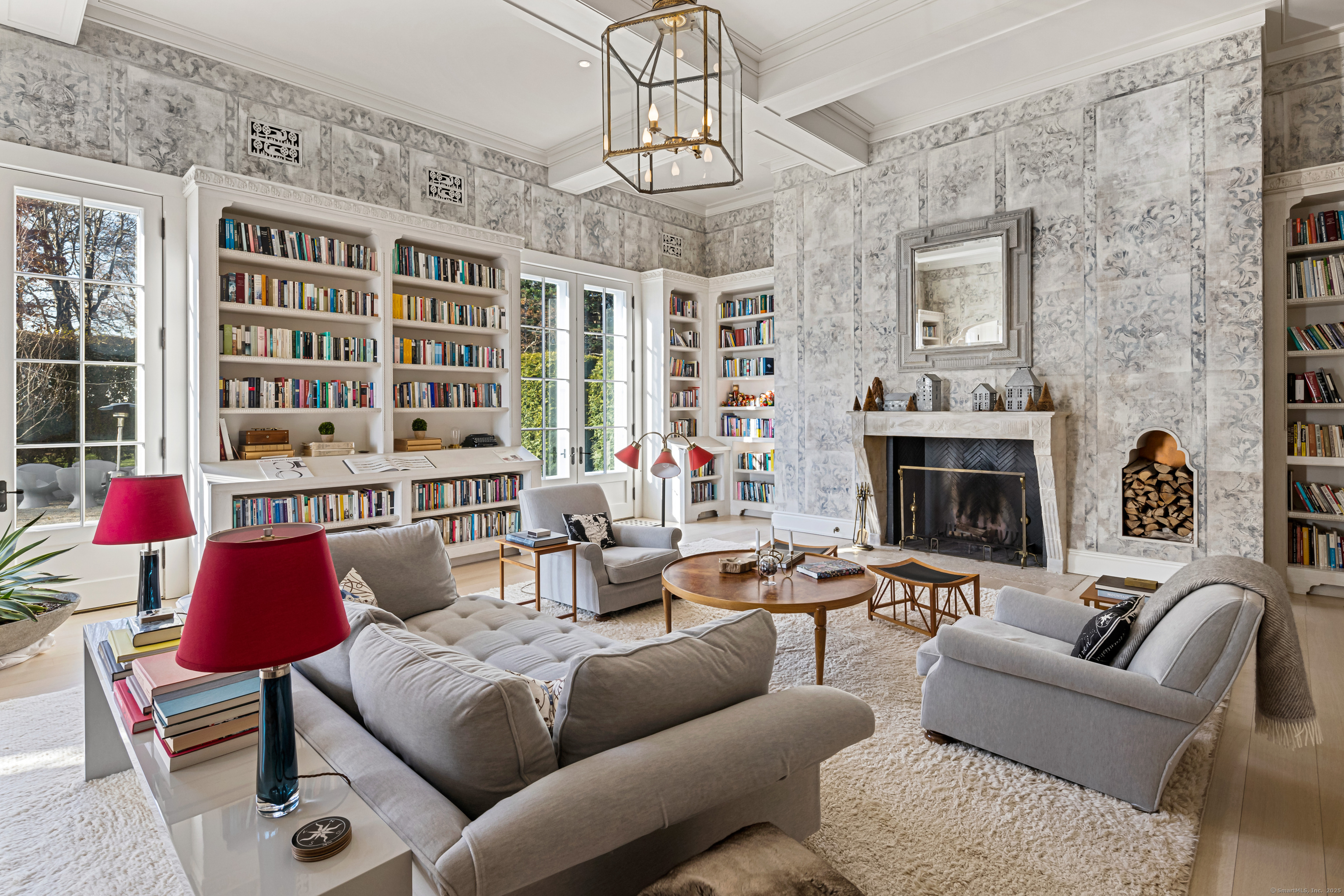 1131 Sasco Hill Road Fairfield, CT 06824 - Photo 8 of 40 a living room with furniture a fireplace and a chandelier