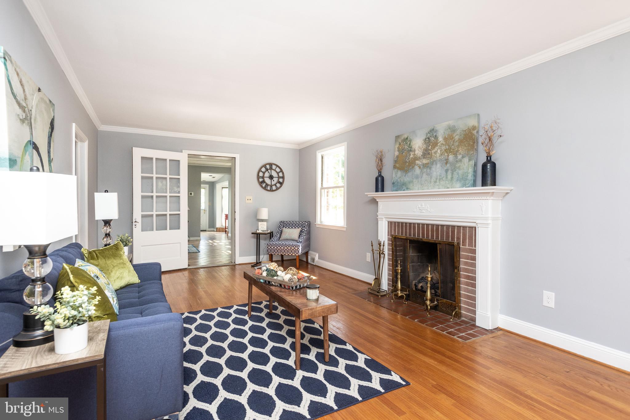 5507 Springlake Way Baltimore, MD 21212 - Photo 2 of 46 Living room w/ original wood floors and fireplace