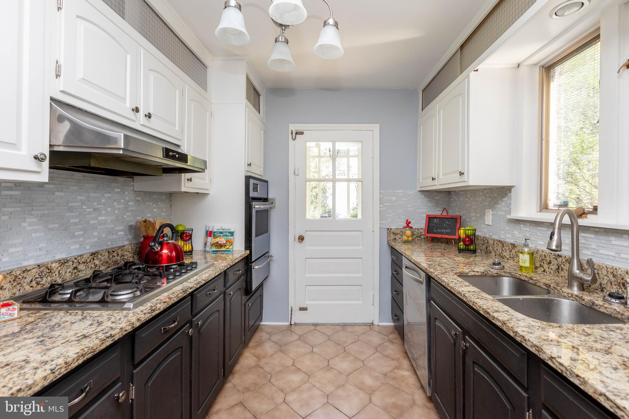 5507 Springlake Way Baltimore, MD 21212 - Photo 10 of 46 Kitchen w/ wood cabinets and granite counters