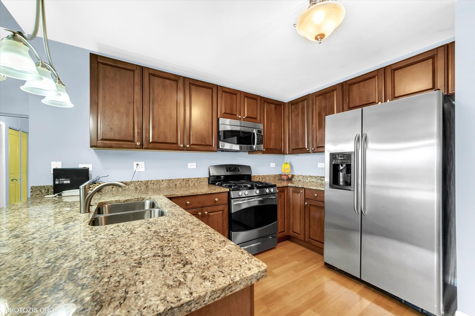 1199 East Port Clinton Road, Unit 201 Vernon Hills, IL 60061 - Photo 6 of 19 a kitchen with granite countertop a refrigerator sink and microwave