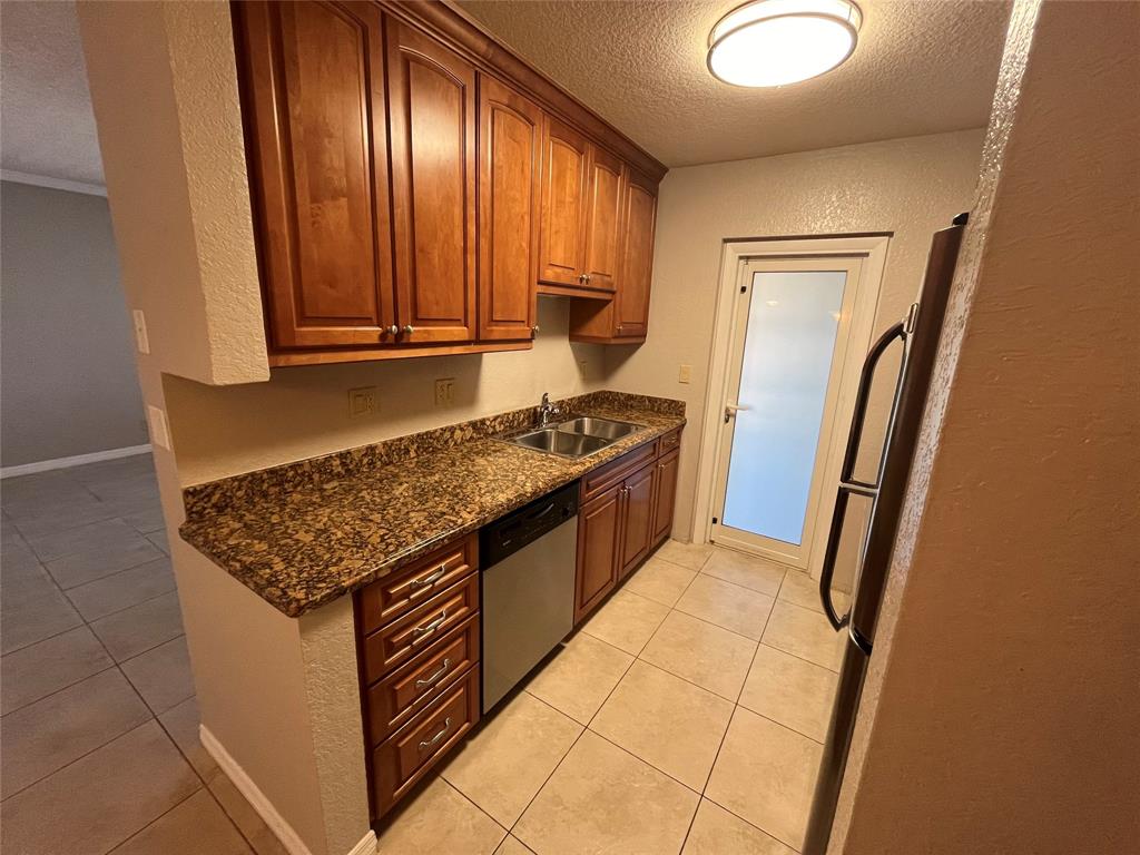 a kitchen with stainless steel appliances granite countertop a refrigerator and a stove