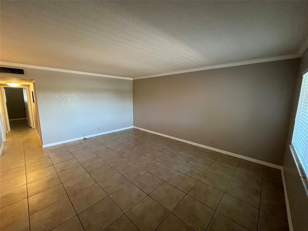 2020 Northeast 56th Street, Unit 208 Fort Lauderdale, FL 33308 - Photo 12 of 54 an empty room with a bench