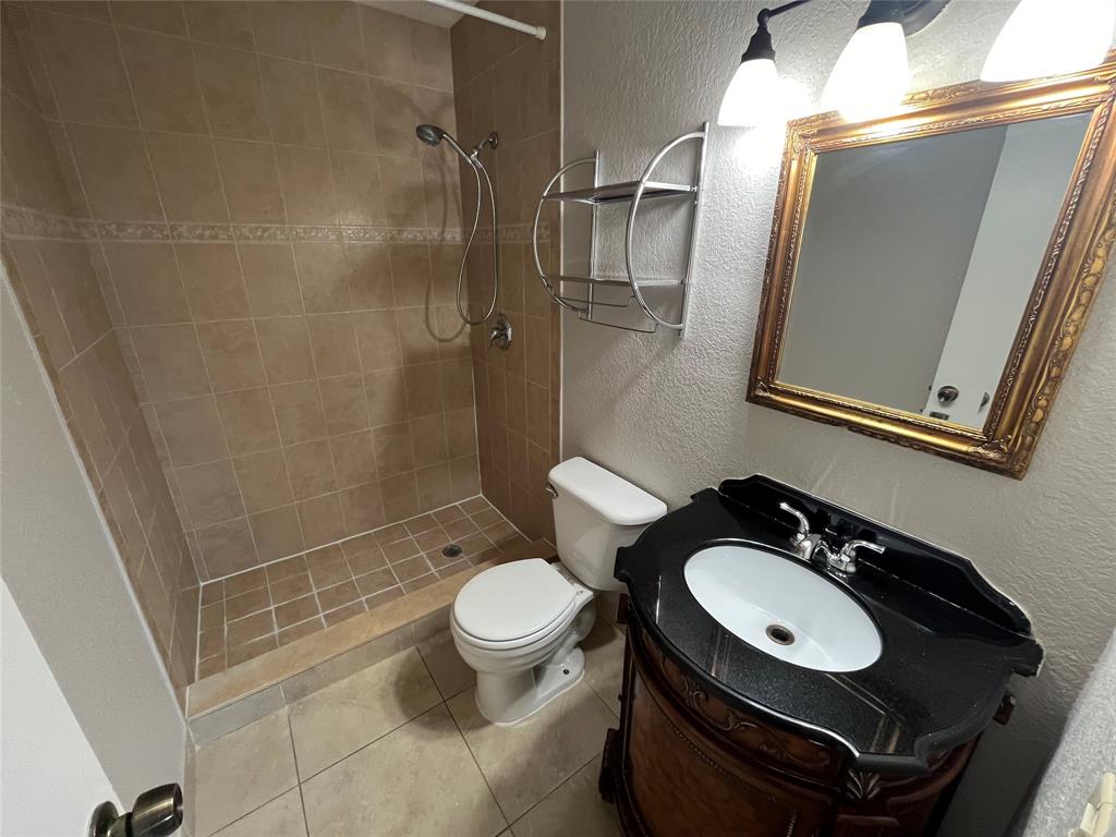 2020 Northeast 56th Street, Unit 208 Fort Lauderdale, FL 33308 - Photo 21 of 54 a bathroom with a sink toilet a mirror and shower