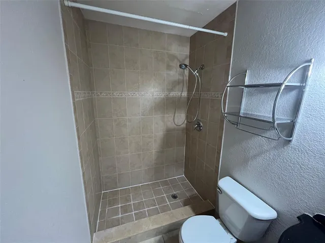 a bathroom with a toilet mirror vanity and a sink