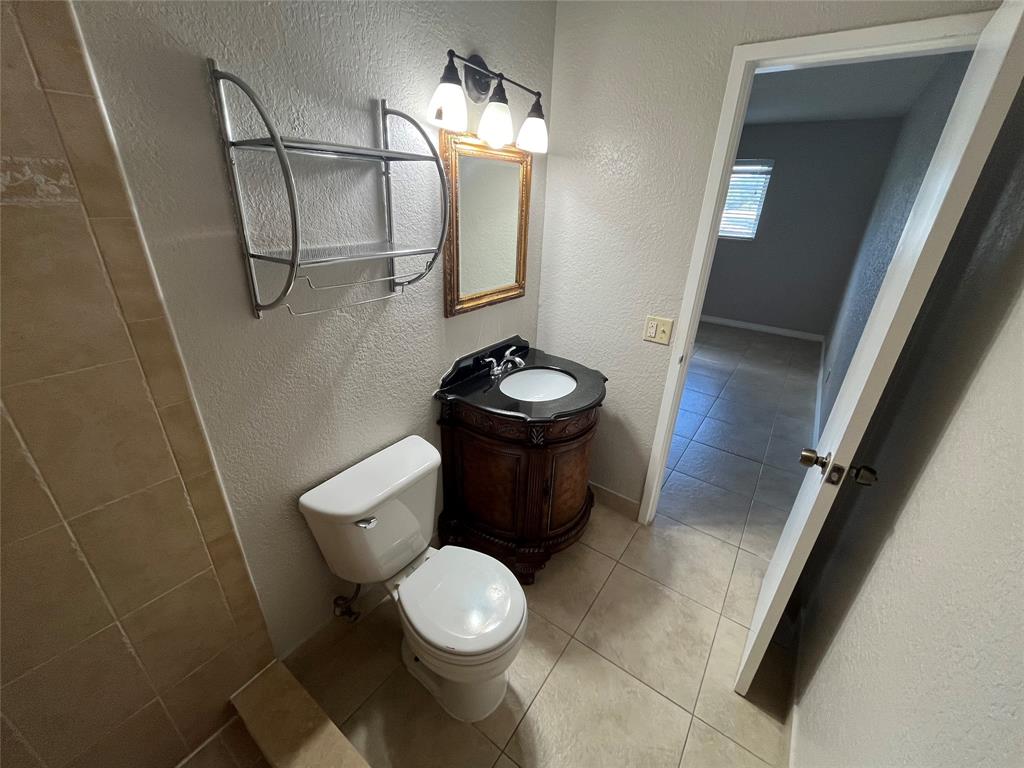 2020 Northeast 56th Street, Unit 208 Fort Lauderdale, FL 33308 - Photo 24 of 54 a bathroom with a toilet mirror vanity and a sink