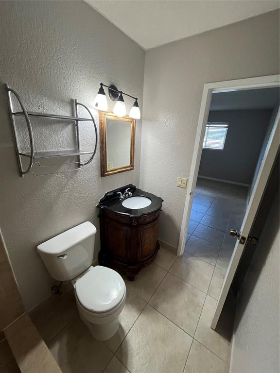 2020 Northeast 56th Street, Unit 208 Fort Lauderdale, FL 33308 - Photo 25 of 54 a bathroom with a toilet a sink and mirror