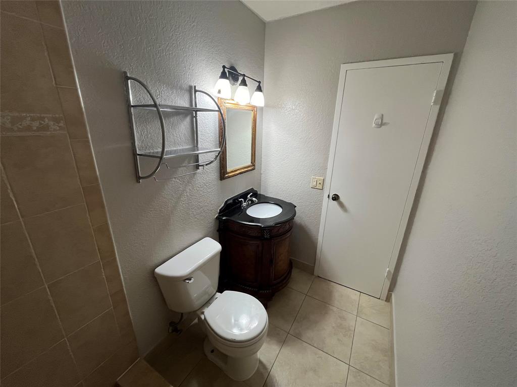 2020 Northeast 56th Street, Unit 208 Fort Lauderdale, FL 33308 - Photo 26 of 54 a bathroom with a toilet and a sink